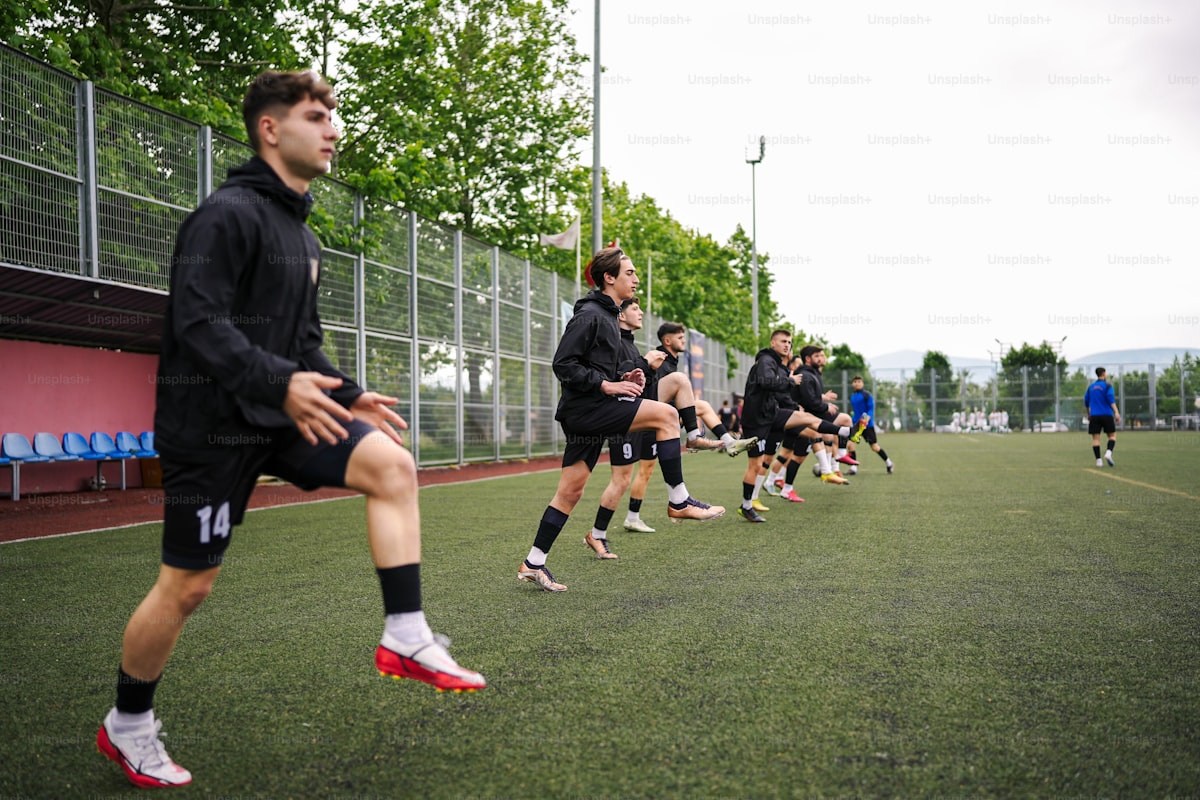 Soccer player sprinting during a beep test on a training pitch