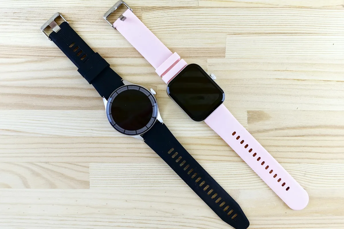 Two smartwatches on a wooden surface, one round and one rectangular, representing different fitness tracker designs