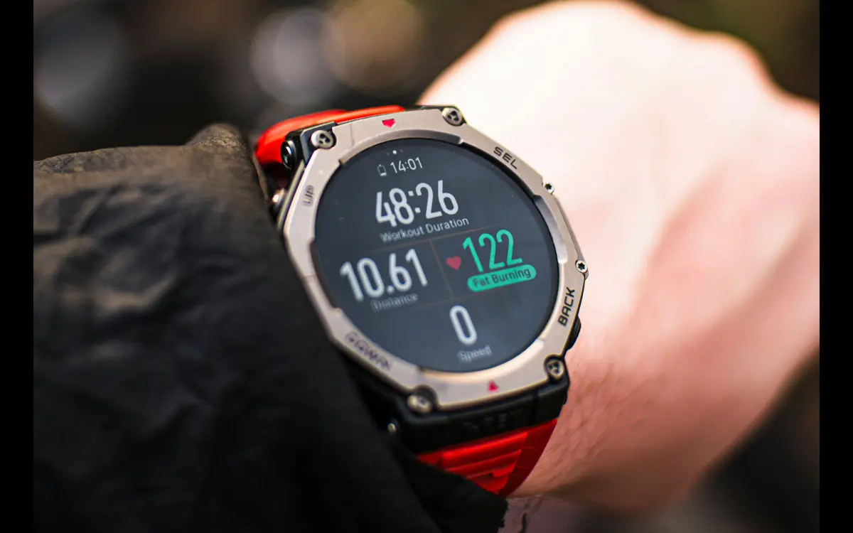 Garmin watch on wrist showing workout stats with heart rate and distance