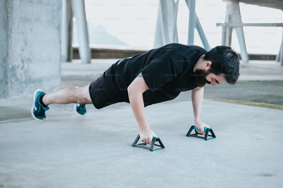 Athlete performing a plank hold for muscular endurance in a gym