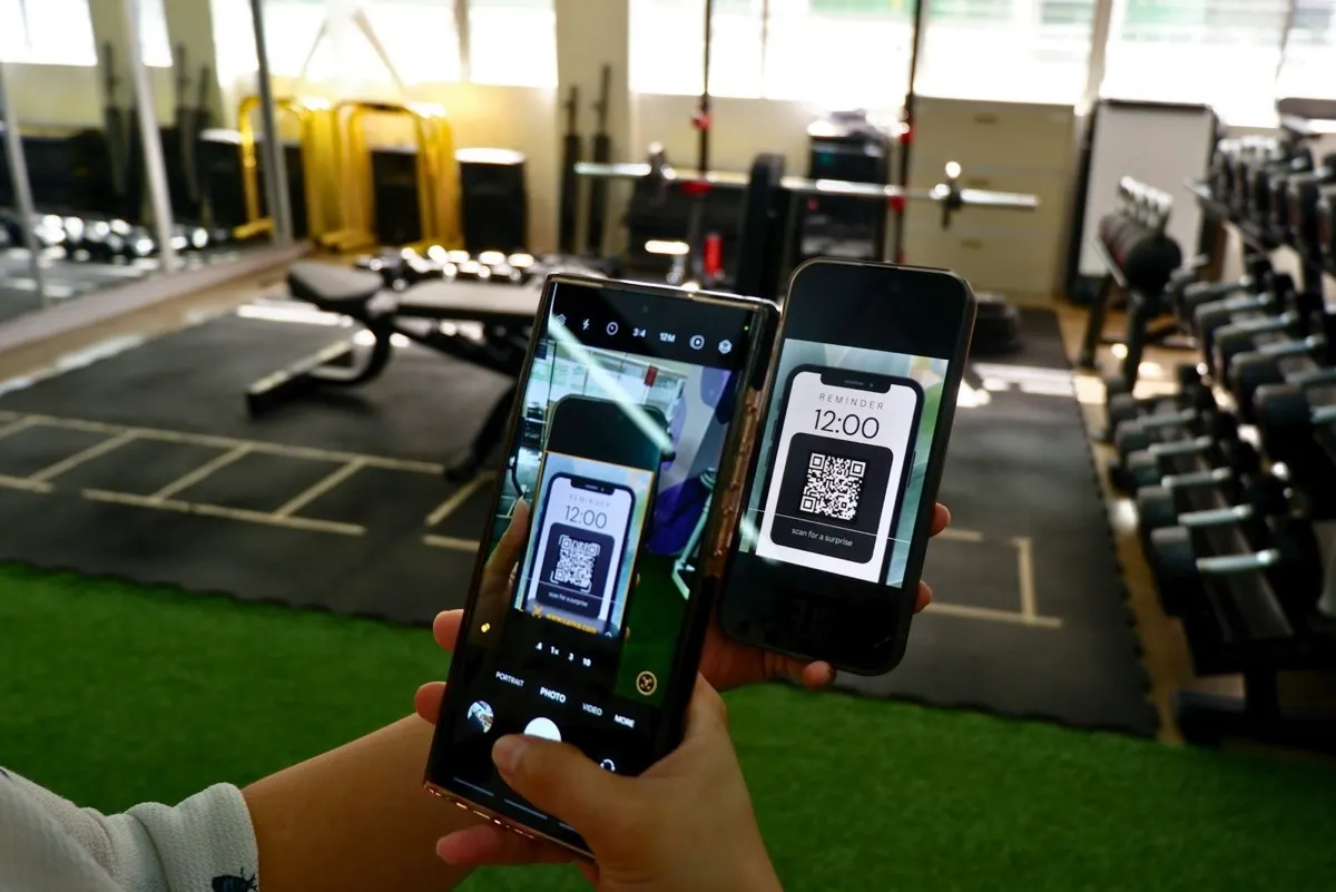 Athlete using a fitness app on a phone in a gym